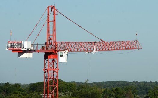 Construction site with tower cranes building residential apartments - rising construction costs